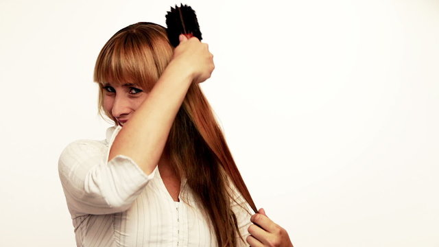Smiling woman brushing her hair