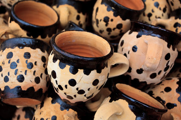 Pile of Handpainted Red Clay Coffee Mugs