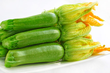 Zucchini with flowers on a white background