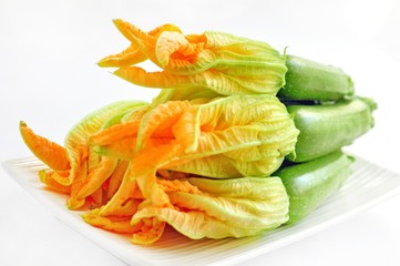 Zucchini with flowers on a white background