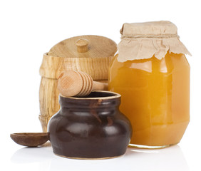 jars and pot full of honey isolated on white
