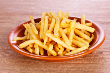French fries on wooden background