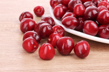 cherry in bowl on wooden background