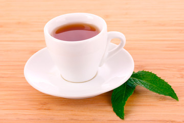 Cup  with mint on wooden background