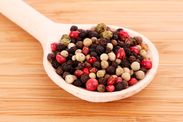 Spices in spoon on wooden table
