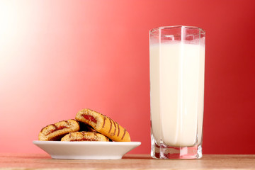 cookies with milk on red background