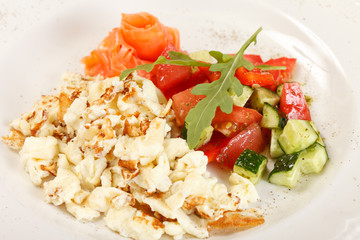 Scrambled eggs with salmon and vegetables
