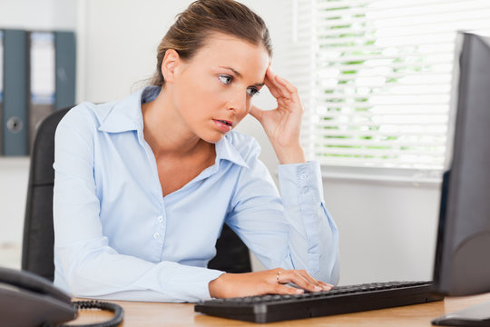 Frustrated woman looking to screen of pc