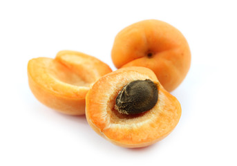 Three apricots on white background