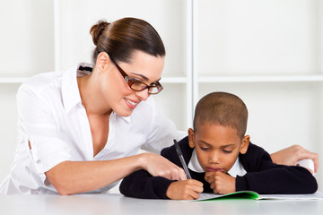 teacher helping primary student