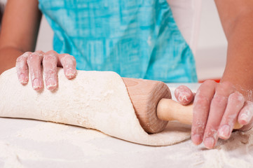 Woman hands mixing dough on the table
