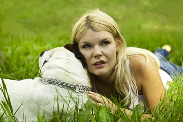 Caucasian young blond woman outdoor with dog