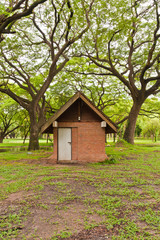 Fototapeta na wymiar Brick hut in park