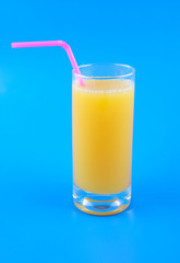 Orange juice in glass with straw