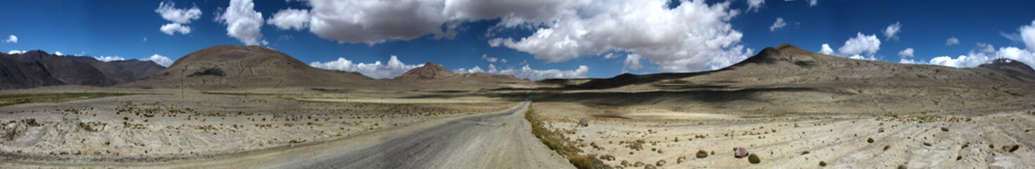Pamir highway disappearing in the horizon of the mountains