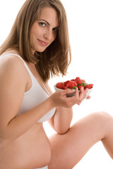 Pregnant woman eating strawberries