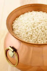 fresh raw risotto on copper pot