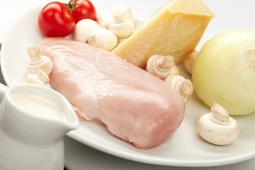 Fresh raw chicken fillets with vegetables