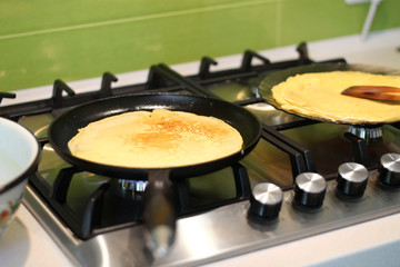 cooking pancakes in a cast iron frying pan