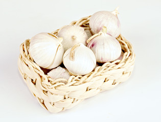 Several garlic onions in a basket isolated