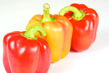 Orange and red pepper isolated on white