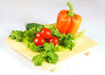 fresh and juicy vegetables on the wood plate isolated