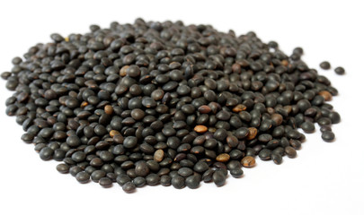 Heap of black lentil isolated on white
