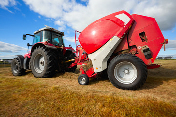 tractor collecting haystack in the field