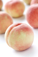 fresh white peaches on white background