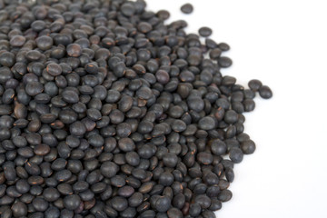 Heap of black lentil isolated on white