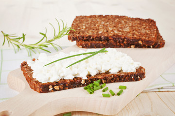 Black bread with cottage cheese.