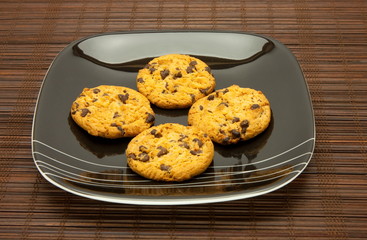 plate of cookies on dark brown background