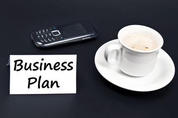 Fototapeta na wymiar Business plan noted on desk with coffee