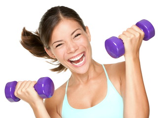 Happy fitness woman lifting dumbbells