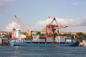 Large container ship in a dock at port - Side view