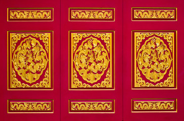 golden dragon on red background in chinese temple, Thailand