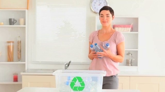 Woman recycling her waste