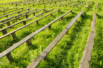 old wooden bench in the summer field and grass