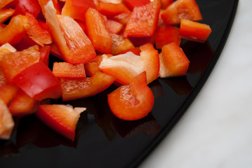 pieces of red paprica on black plate