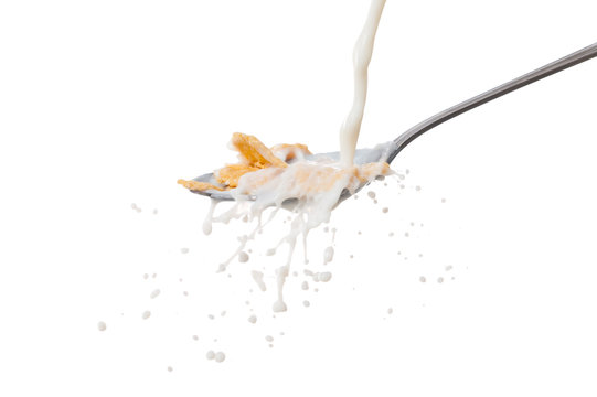 Milk Splash On The Spoon With Cornflakes On White Background