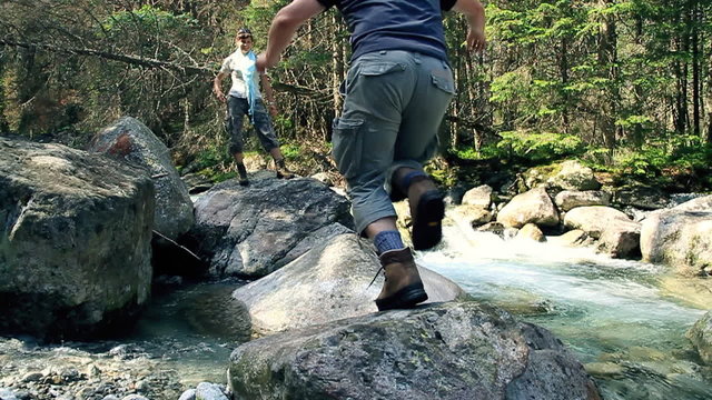 Mun jumping on the rocks in the forest stream, slow motion
