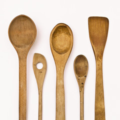 different kitchen wooden utensils on a white background