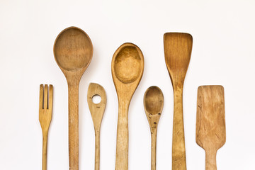 different kitchen wooden utensils on a white background