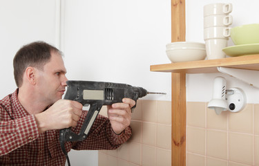Drilling the hole in a kitchen wall