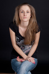 Fototapeta premium Smiling girl sitting on a stool