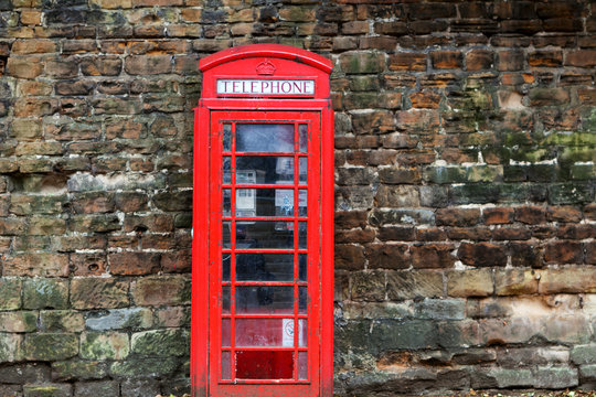 The British red phone booth on old wall