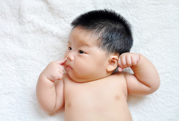 Baby lying on the bed