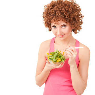 fun woman eating the salad on the white background