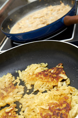Meat cut strips with in potato rosti in a pan