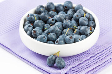 Ripe fresh blueberry in white bowl close-up